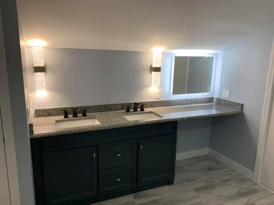Bathroom vanity with granite countertop and lighting